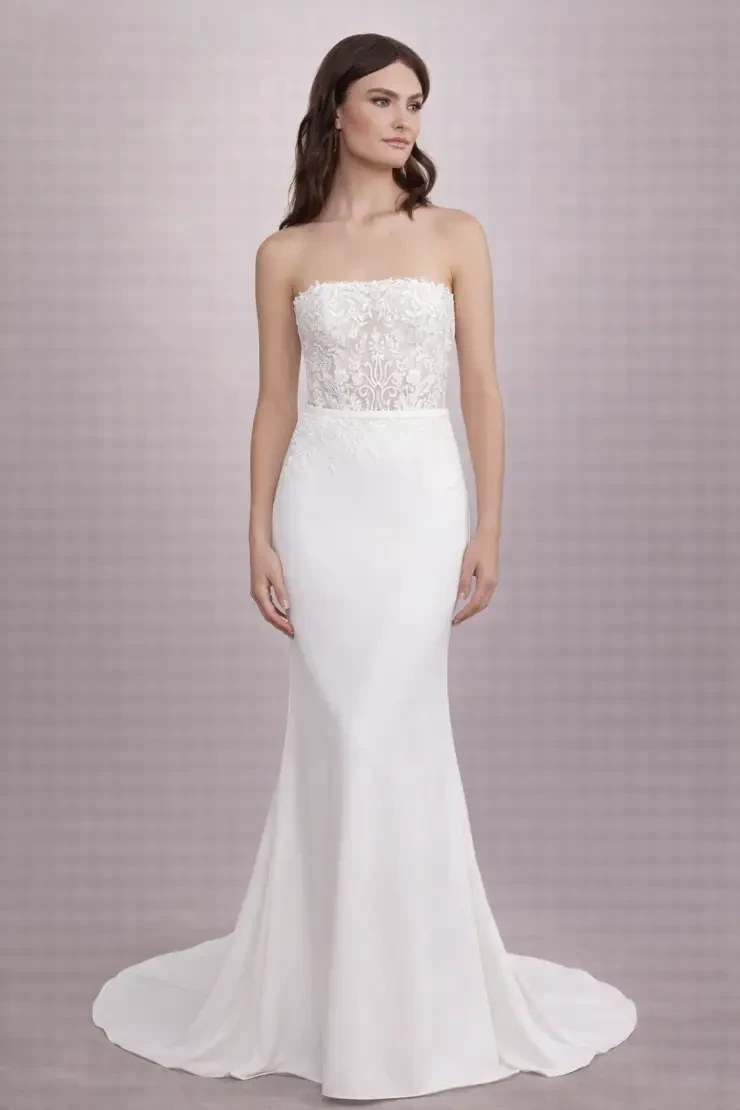 model is wearing a fitted strapless wedding gown
