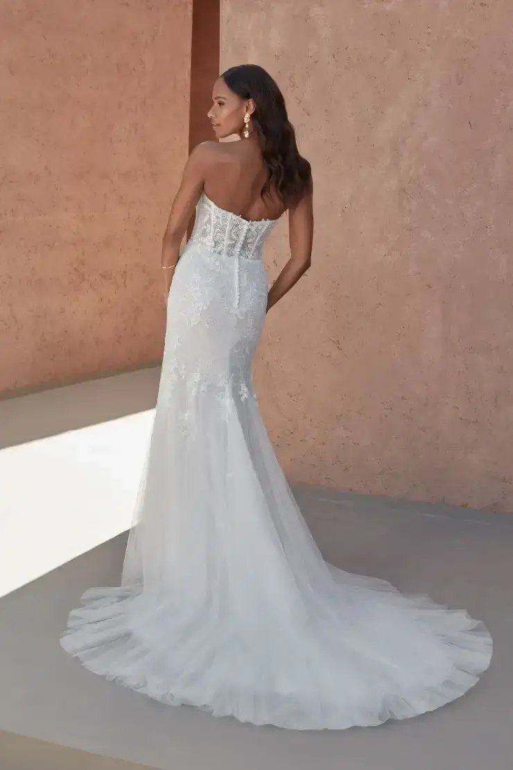 model is wearing a strapless lace mermaid bridal gown
