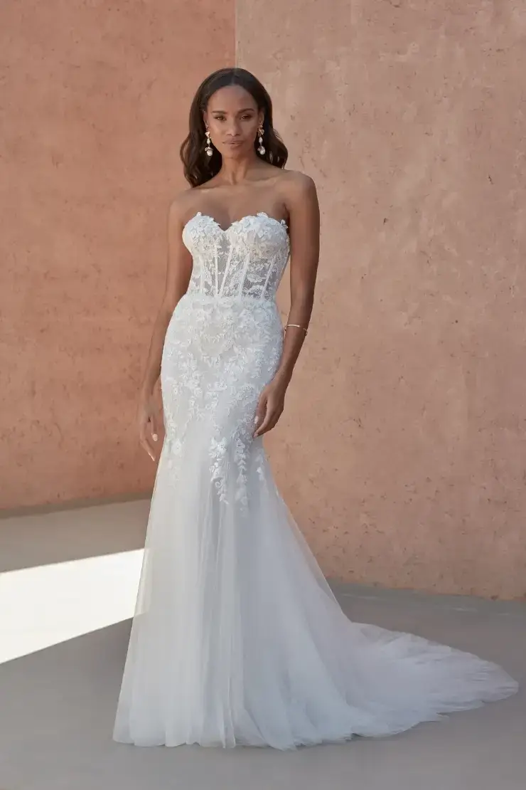 model is wearing a strapless lace mermaid bridal gown