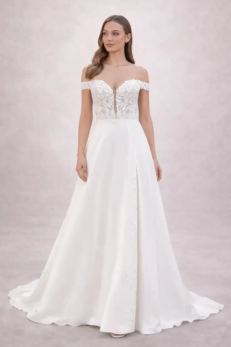 A woman wearing a white off-the-shoulder wedding gown with a fitted bodice and a full skirt.