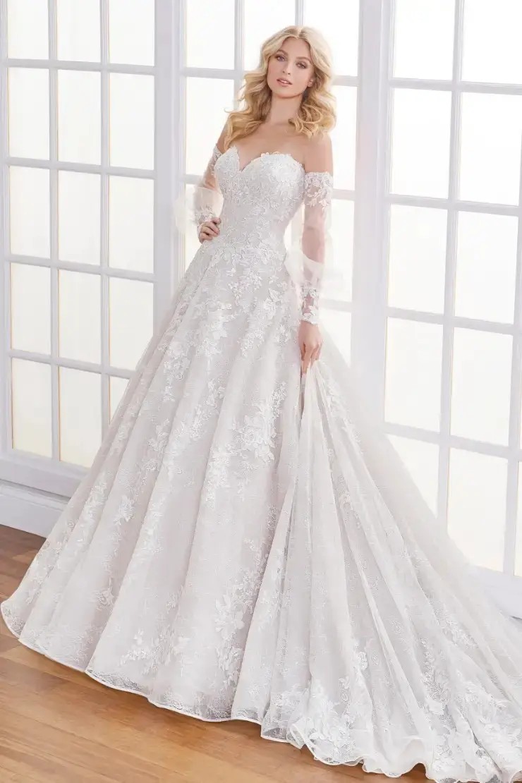 Model is wearing a lace and tulle ball gown wedding dress by martin thornburg