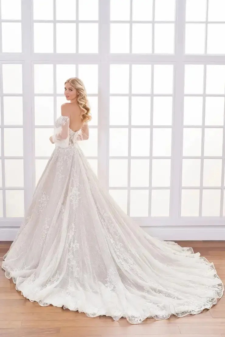 Model is wearing a lace and tulle ball gown wedding dress by martin thornburg