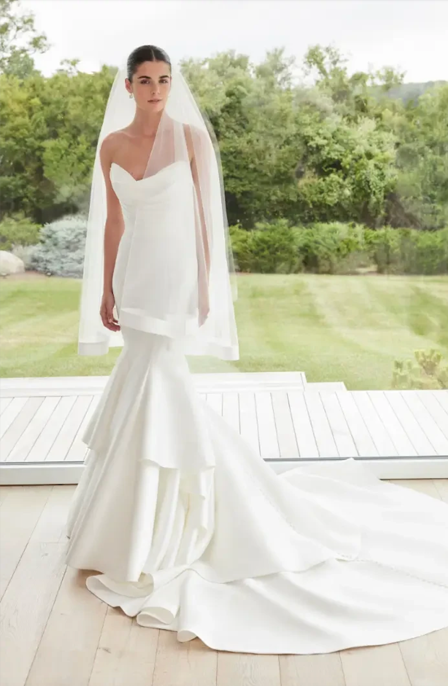 model is wearing a strapless fit and flare wedding dress