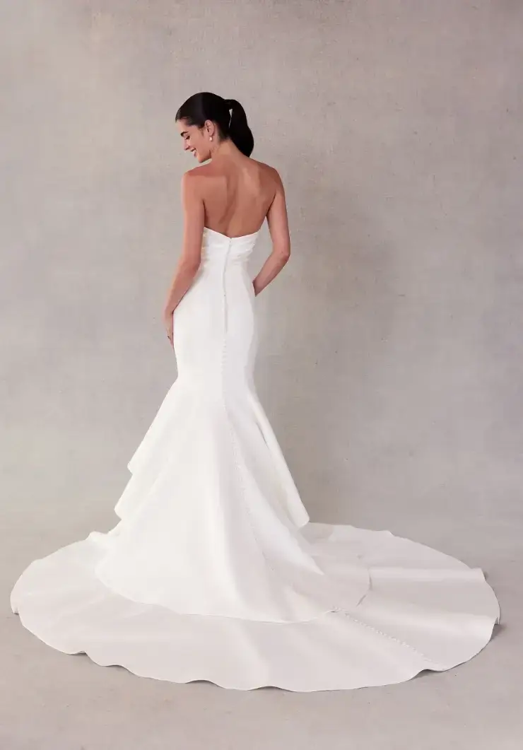 model is wearing a strapless fit and flare wedding gown