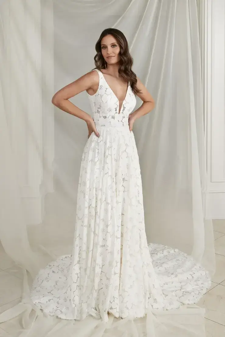 model is wearing a sleeveless lace a-line wedding dress