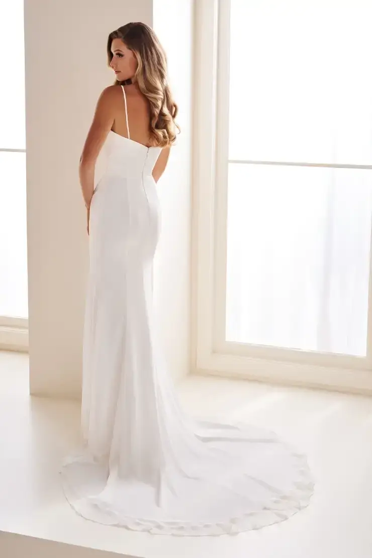 model is wearing a sleeveless cowl neck satin wedding dress