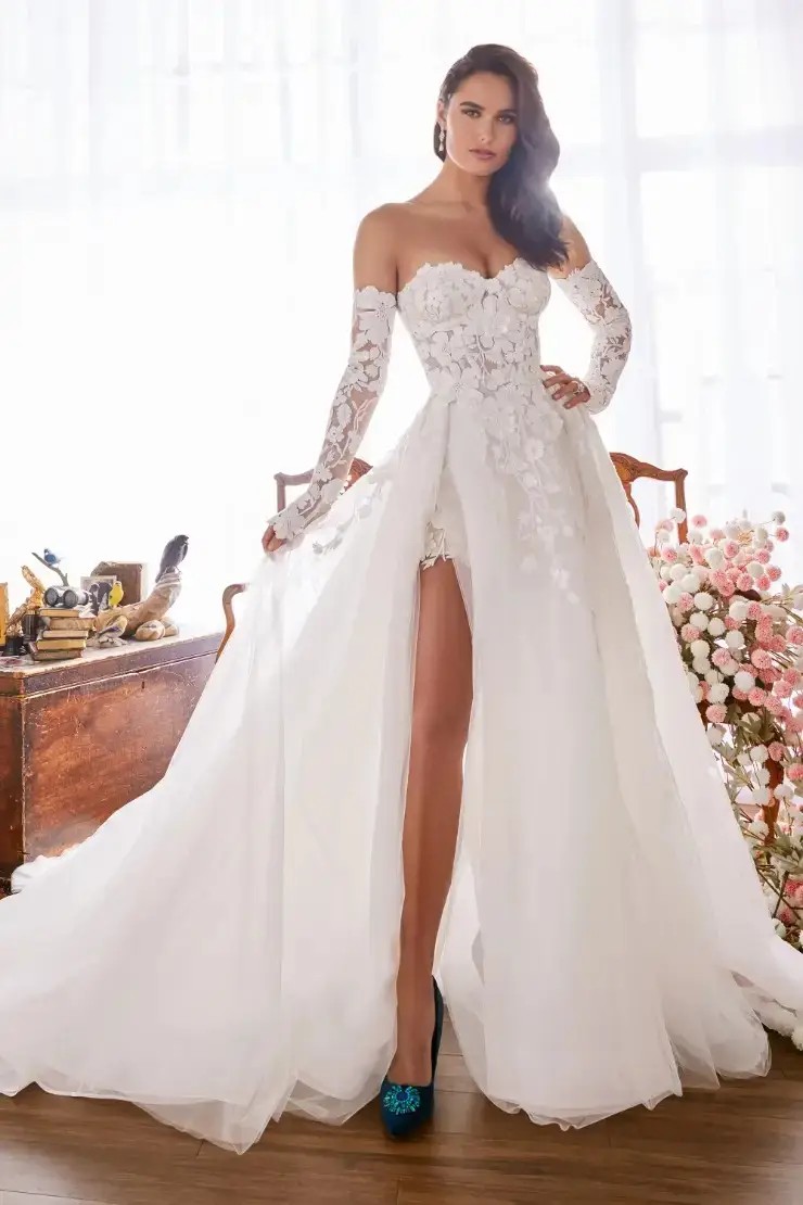 Model is wearing a ball gown wedding dress with a sweetheart neckline and thigh high slit by martin thornburg