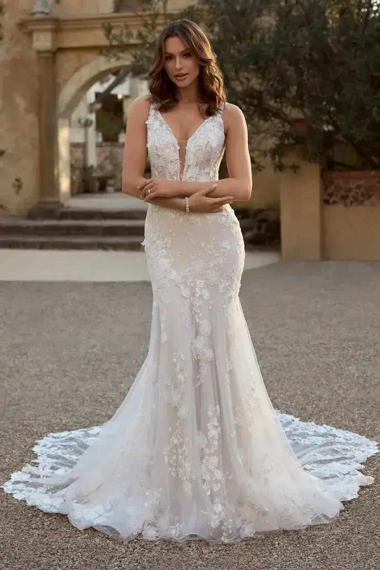 model is wearing a sleeveless wedding gown