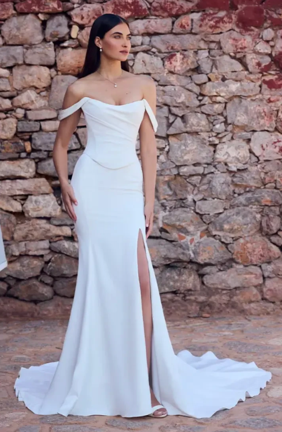 model is wearing a minimalist sheath wedding dress 
